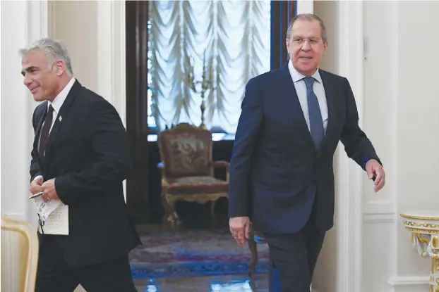  ?? (Alexander Nemenov/Reuters) ?? RUSSIAN FOREIGN Minister Sergei Lavrov and his Israeli counterpar­t, Yair Lapid, enter a hall during a meeting in Moscow, last year in friendlier times.