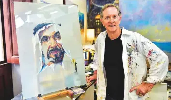  ?? Clint Egbert/Gulf News ?? Mike Arnold, who started painting just five years ago, with his oil on glass of Shaikh Zayed.