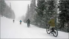  ?? MIKE HAWKINS/For Angel Fire Resort ?? Bikes make their way down the steep, snow-covered trail during the season-ending Chili Challenge at Angel Fire Ski Resort Sunday (March 24). The Resort will now shift its attention to the upcoming summer season.