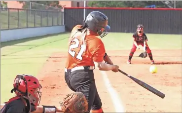  ?? Scott Herpst ?? Lafayette’s Madi Ashley takes a swing at a pitch during last Tuesday’s game, while LFO third baseman Julie Shore gets in position to make a play on the ball. LFO won 6-0 in the region opener for both clubs.