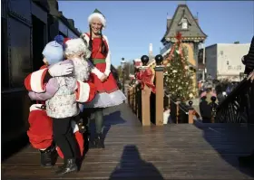  ?? LAUREN A. LITTLE — MEDIANEWS GROUP ?? Santa gets a hug from Arabella Schipper, 5, after a ride on the Colebrookd­ale Railroad’s Santa’s Polar Bear Express.