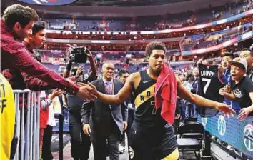  ?? AP ?? Toronto Raptors guard Kyle Lowry celebrates with fans as he leaves the court after Game 6 of the NBA first-round play-off series against Washington Wizards.