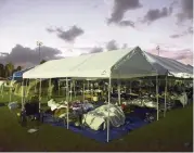  ?? CARLOS GIUSTI AP ?? Residents of Guayanilla, Puerto Rico, awake at sunrise Friday in tents and cots that were set up at a baseball stadium for those whose homes are either destroyed or deemed unsafe to enter after this week’s earthquake.