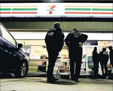  ?? Chris Carlson Associated Press ?? UNDER the Trump administra­tion, ICE is beefing up work site enforcemen­t and boosting its presence in “sanctuary” jurisdicti­ons such as California. Above, ICE agents at a 7-Eleven store in Los Angeles last month.