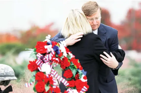  ??  ?? Republican Gov.-elect Tate Reeves, hugs Jenny Smith, a Gold Star mother, following a Veterans Day ceremony at the Museum of Mississipp­i History and Mississipp­i Civil Rights Museum in Jackson, Miss., Nov. 8, 2019. Smith and her husband Eddie Smith, lay a memorial wreath on Entergy Plaza outside the museums, honoring all veterans and her late son, Marine Staff Sgt. Jason A. Rogers, who was killed in an explosion two days before what would have been his 29th birthday, in April 7, 2011. (Photo by Rogelio V. Solis, AP)