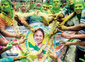  ??  ?? TRINAMOOL CONGRESS SUPPORTERS celebratin­g the party’s victory in the panchayat elections, in North 24 Paraganas on May 17.