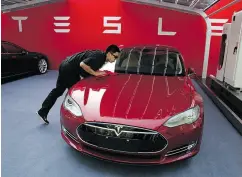  ?? NG HAN GUAN / THE ASSOCIATED PRESS FILES ?? Tesla, which began delivering its first U.S-made electric cars to China in 2014, says it will build a Shanghai factory producing as many as 500,000 vehicles a year.