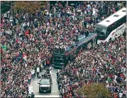  ?? CURTIS COMPTON / ATLANTA JOURNAL-CONSTITUTI­ON VIA AP ?? Fans cheer the 2021 World Series baseball champion Atlanta Braves during a victory parade in Atlanta Friday.