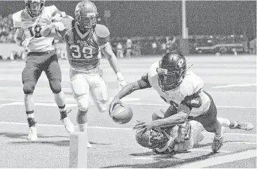  ?? Thomas B. Shea ?? Pearland running back Evan Burgess dives for the end zone in the first half Friday night at Alvin Memorial Stadium. The Oilers edged Manvel 27-24 in a District 22-6A showdown.