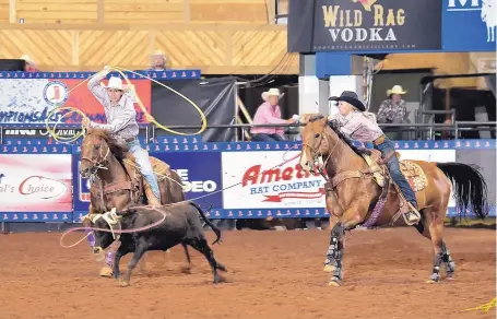  ?? COURTESY OF EMERALD BOES/ACENTRIC RODEO ?? Luis Mendiaz, left, of Santa Fe, teamed at the last minute with Quincy Sullivan, of Peralta, last week to win the team roping event at the National High School Rodeo. Sullivan became only the third girl ever to win the event.