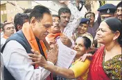  ?? PTI FILE ?? Gujarat chief minister Vijay Rupani meets with people during a doortodoor campaign in Ahmedabad.
