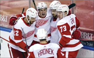  ?? JIM RASSOL — THE ASSOCIATED PRESS ?? Detroit Red Wings’ Patrik Nemeth, left, Dylan Larkin, center, Filip Zadina, second from right, Adam Erne, right, and Filip Hronek, bottom, celebrate Zadina’s goal during Tuesday’s 2-1loss to the Florida Panthers. Detroit is at Nashville today.