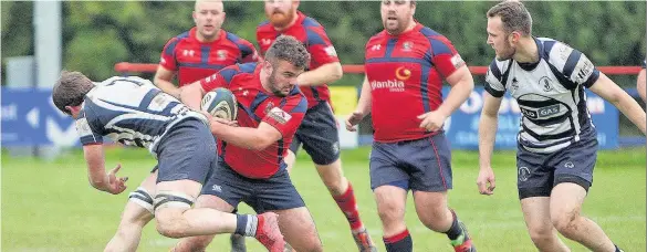  ??  ?? Llangefni’s Sior Greaves side steps this Colwyn Bay challenge.