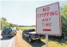  ??  ?? A sign near a field of sunflowers on Jarrettsvi­lle Pike near Hess Road is widely ignored by motorists who want to get a good view of the crop.