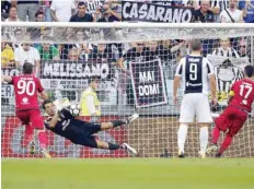  ?? — AFP ?? Juventus’ goalkeeper Gianluigi Buffon saves a penalty kick during the Serie A match against Cagliari at the Allianz Stadium in Turin.
