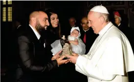  ??  ?? Wassim “Sal” Slaiby, Rima Fakih Slaiby, and baby Rima W Slaiby, meet Pope Francis at The Vatican in Vatican City.