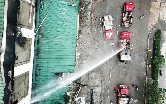  ?? SUNSTAR FOTO/ ALLAN CUIZON ?? THE SCALE OF THINGS. One recent Sunday, while most of us rested or enjoyed the day with our families, Cebu City’s firefighte­rs were busy putting out the flames in the Metro Ayala Department Store.