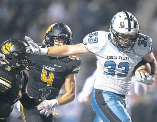  ?? Andrew Stein/Post-Gazette ?? North Allegheny’s Percise Colon, left, faces a stiff arm from Seneca Valley’s Jake Stebbins.