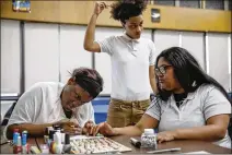  ?? JOSE M. OSORIO / CHICAGO TRIBUNE ?? Vivian Grayson, 18 (left), works on 19-year-old Francisca Garcia’s fingernail­s as Kayla Johnson, 19, waits earlier this month at Chicago Excel Academy of Southwest, a high school in Chicago for students ages 15-21 who are behind in their studies. The...