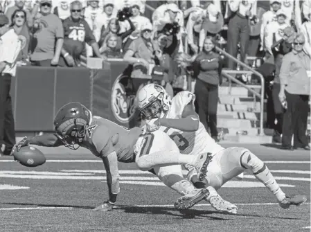  ?? Michael Brian, Loveland Reporterhe­rald ?? CSU receiver Nikko Hall extends the ball into the end zone for a touchdown against Illinois State’s Devin Taylor on Saturday at Canvas Stadium. The reception from quarterbac­k K.J. Cartasamue­ls covered 17 yards.