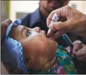  ?? ?? A child is given a polio vaccinatio­n by a district health team worker May 30, 2012, outside a children’s hospital in Peshawar, Pakistan.