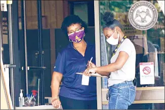  ?? Sept 3. (AP) ?? An employee of the Mississipp­i Department of Employment Security WIN Job Center in Pearl, Miss (left), assists a client fill out paperwork on Aug 31, 2020. The Labor Department reported unemployme­nt numbers Thursday,