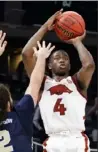  ?? Getty Images ?? Arkansas’ Davonte Davis eyes the shot that beat Oral Roberts Saturday night in Indianapol­is.