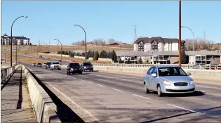  ?? NEWS FILE PHOTO ?? Traffic drives across the Trans-Canada Bridge in Medicine Hat in this November 2019 file photo. The United Conservati­ves have introduced legislatio­n that would allow them to charge tolls on new roads and bridge projects.