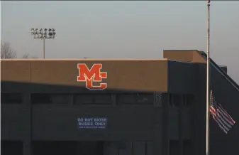  ?? Ryan Hermens / Paducah Sun ?? A flag at Marshall County High School in Benton, Ky., flies at half-staff Thursday. The school reopened Friday, three days after a student went on a shooting spree and killed two teenagers.