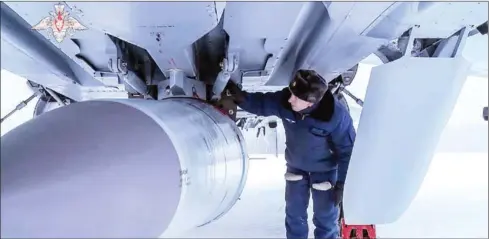  ?? AFP ?? An airman examining MiG-31K fighter of the Russian air force carrying a Kinzhal hypersonic cruise missile during the Grom-2022 Strategic Deterrence Force exercise at an undefined location in Russia.