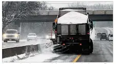  ??  ?? Beavercree­k road crews put salt down on U.S. 35 Sunday in an effort to get dangerous conditions under control.