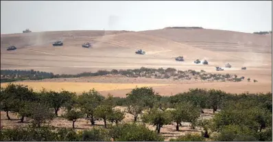  ?? AP ?? Turkish tanks and Syrian opposition forces backed by Turkey move toward the Syrian border Wednesday in the assault on Islamic State forces in the city of Jarablus. Officials said Islamic State fighters retreated quickly when Turkish troops crossed the...