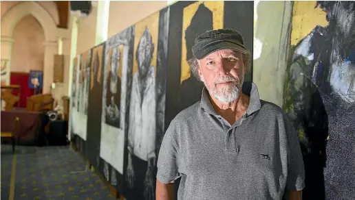  ?? BEJON HASWELL/ STUFF ?? Artist John Badcock stands with his last supper exhibition now on display at Geraldine’s St Mary’s Church. The exhibition features 13 panels of self portraits measuring 13 metres long.