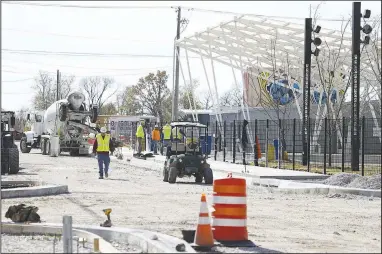  ?? (NWA Democrat-Gazette/Charlie Kaijo) ?? Workers complete constructi­on Friday at a constructi­on site along Arkansas Street at the intersecti­on with Poplar Street. Visit nwaonline.com/221030Dail­y/ for today’s photo gallery.