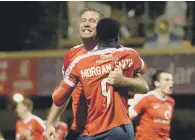 ?? PICTURE: BRUCE ROLLINSON ?? Jon Parkin celebrates with Amari Morgan-Smith after making it 5-3 from Sam Muggleton’s long throw.