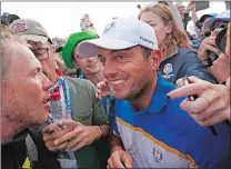  ?? LAURENT CIPRIANI/AP PHOTO ?? Europe’s Francesco Molinari celebrates with fans after winning his singles match to clinch the Ryder Cup for Europe on the final day of competitio­n at Le Golf National in Saint-Quentin-enYvelines, outside Paris, France on Sunday.