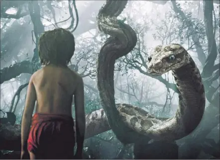  ?? Disney Enterprise­s ?? AN UNDAUNTED MOWGLI (newcomer Neel Sethi) encounters the giant python Kaa (hypnotical­ly voiced by Scarlett Johansson).