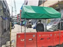  ??  ?? Police posted one of the 13 controlled points along Mabuhay Street at the start of three-day lockdown of some 10 targeted streets in Brgy. Baclaran that said to have high concentrat­ion of Covid-19 cases from May 21 to May 23.
21 of which are from Baclaran. 42 perished. She added that the Records also showed that 335 city has tested roughly 7,000 covid recovered from the disease while cases to date.