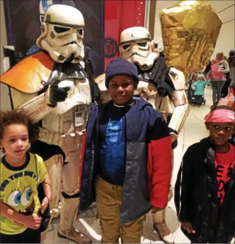  ?? PHOTOS BY PAUL POST — PPOST@DIGITALFIR­STMEDIA.COM ?? Janell Brown, left, and brothers Daniel and Darius Williams, met Star Wars characters during Kidz Expo at Empire State Plaza in Albany on Saturday.