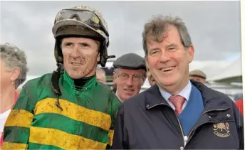  ??  ?? Jockey Tony McCoy, left, and owner JP McManus in 2013 in the winners’ enclosure after victory in thetote.com Galway Plate with Carlingfor­d Lough