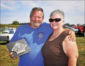  ?? CARL HESS - DIGITAL FIRST MEDIA ?? Carson Krause of Lenhartsvi­lle proudly accepts the Pastors Place award plaque from Maryann Rhode for his 1931 Model A Ford Coupe.