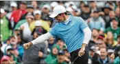  ?? CONTRIBUTE­D BY JASON GETZ ?? Rory McIlroy celebrates his birdie putt on No. 18 to finish his bogey-free, 7-under 65 in the third round of the Masters on Saturday.