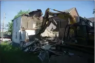  ?? ?? Demolition of 660 4th Street, an unsafe/vacant zombie property located in the city’s South Troy neighborho­od.