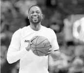  ?? WILFREDO LEE/ASSOCIATED PRESS ?? Miami Heat guard Dwyane Wade smiles as he warms up for the team’s game against Milwaukee on Friday.