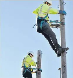  ??  ?? Trainee BT engineers practise climbing telecom poles at Openreach’s training centre at Livingston.