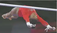  ?? MATTHIAS SCHRADER/ASSOCIATED PRESS ?? Simone Biles performs on the uneven bars in the women’s apparatus finals Saturday at the Gymnastics World Championsh­ips in Stuttgart, Germany.