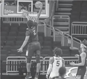  ?? MARQUETTE ATHLETICS ?? Marquette’s Justin Lewis soars in for a dunk during the first half Tuesday night, but the second half against Connecticu­t did not go well.