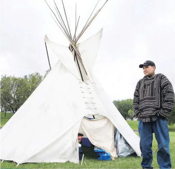  ?? KAYLE NEIS ?? Chris Martell stands in front of the teepee he has put up at the Healing Camp for Justice in Victoria Park. Martell, whose toddler son drowned while in foster care in 2010, says his goal with the ‘peaceful protest’ camp is to draw attention to the...