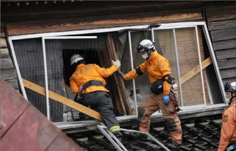  ?? Hiro Komae/Associated Press ?? Rescue workers search a collapsed house following a powerful earthquake Jan. 1 in Suzu, Ishikawa Prefecture, Japan.