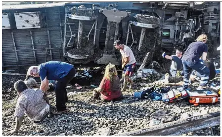  ?? — AFP ?? In need of help: Rescuers tending to injured people near several derailed wagons after the train accident at Corlu district in Tekirdag, Turkey.